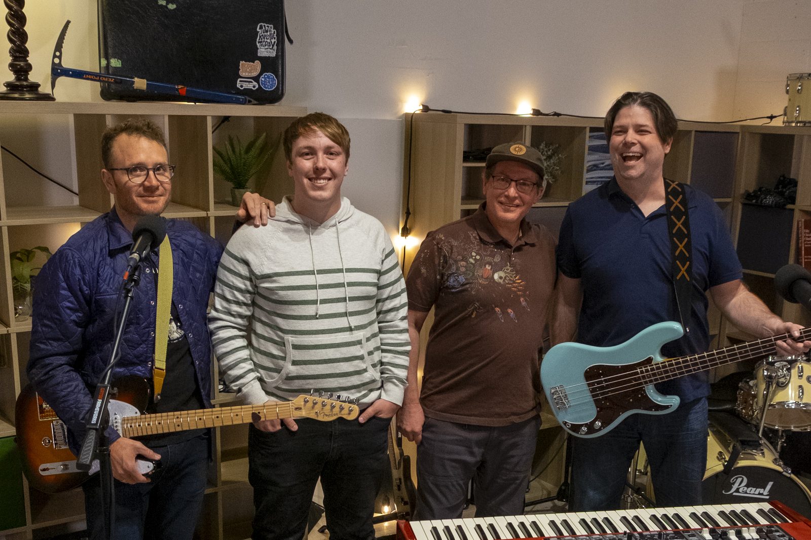The four members of The Andes posing together in their rehearsal space