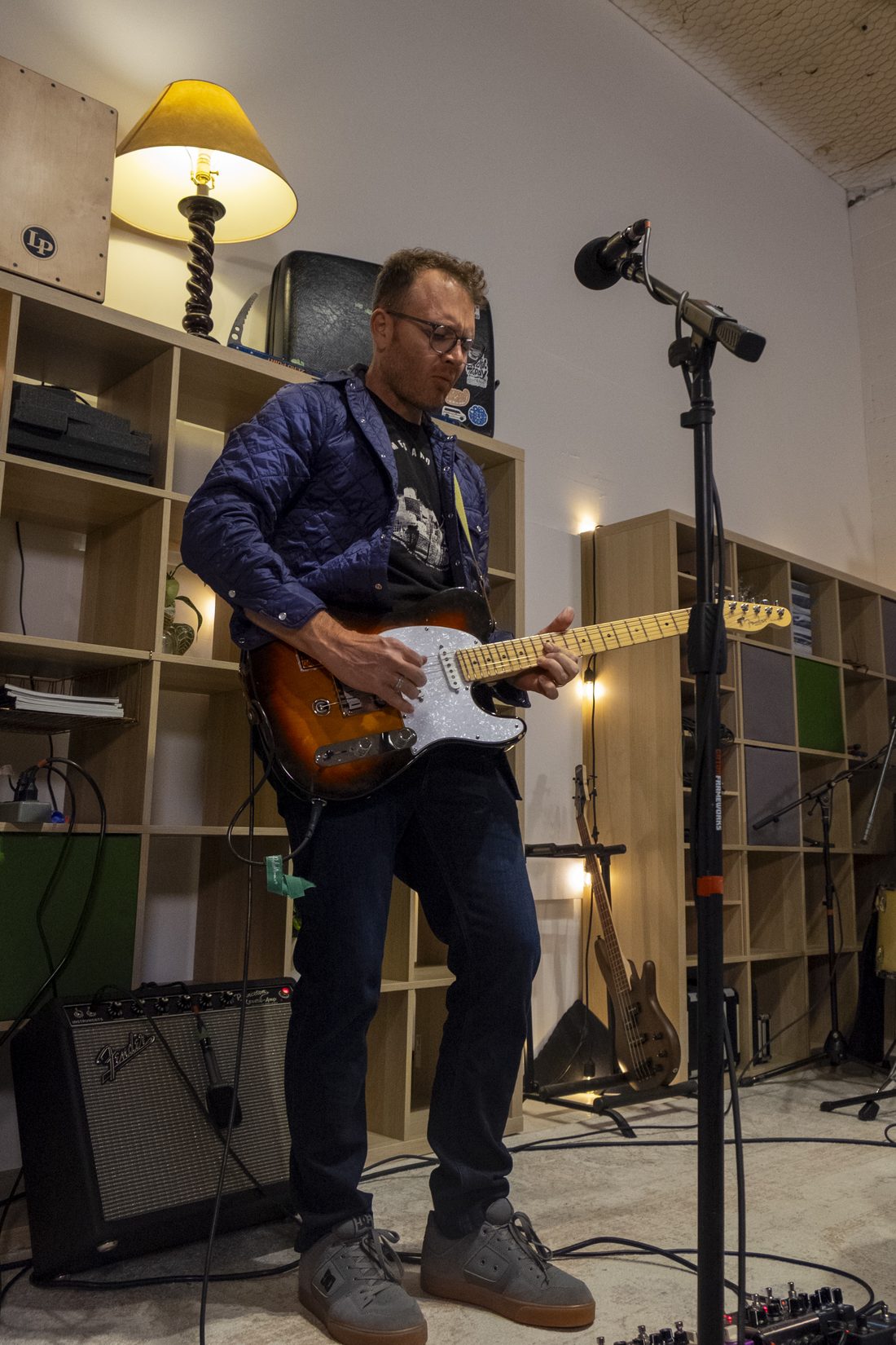 Guitarist playing a sunburst Telecaster in the rehearsal room